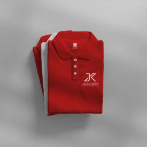 a neatly folded red polo shirt with jacks graph logo on the chest and size m on the collar label, placed on a white surface with another red garment partially underneath.